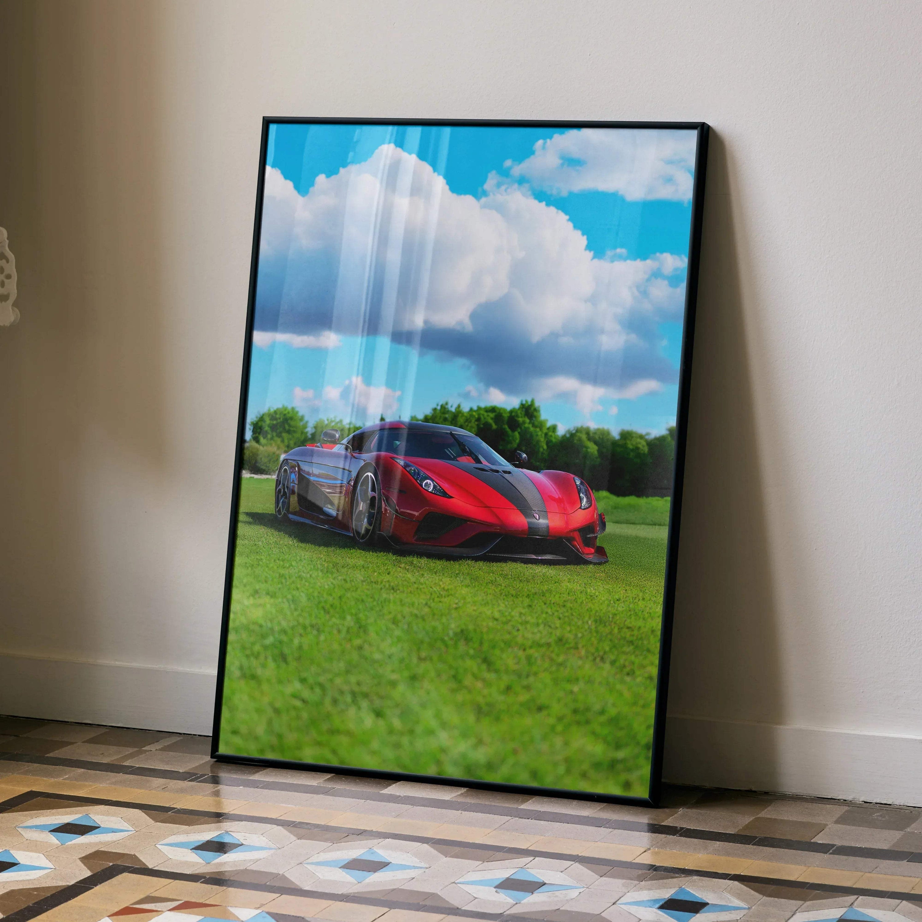 Koenigsegg Regera red sports car on grass with blue sky poster wall art in black frame.