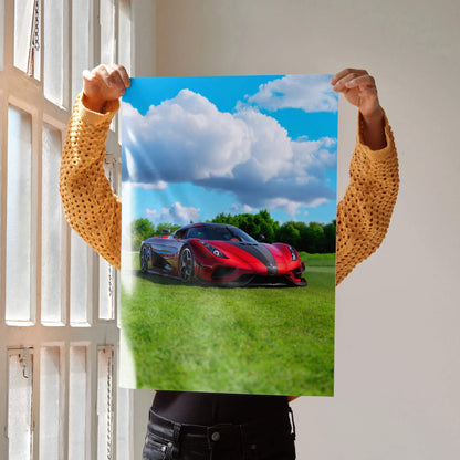 Koenigsegg Regera poster showing red sports car on green field under blue sky wall art.