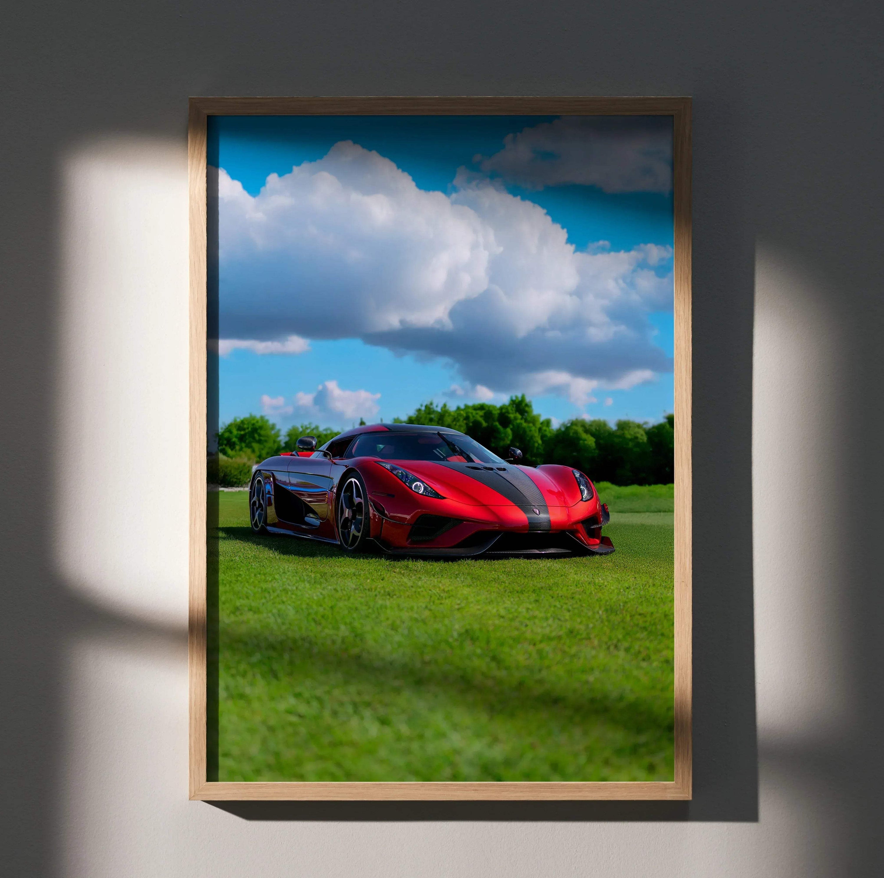 Koenigsegg Regera sports car in red on grass under blue sky poster wall art in wooden frame.