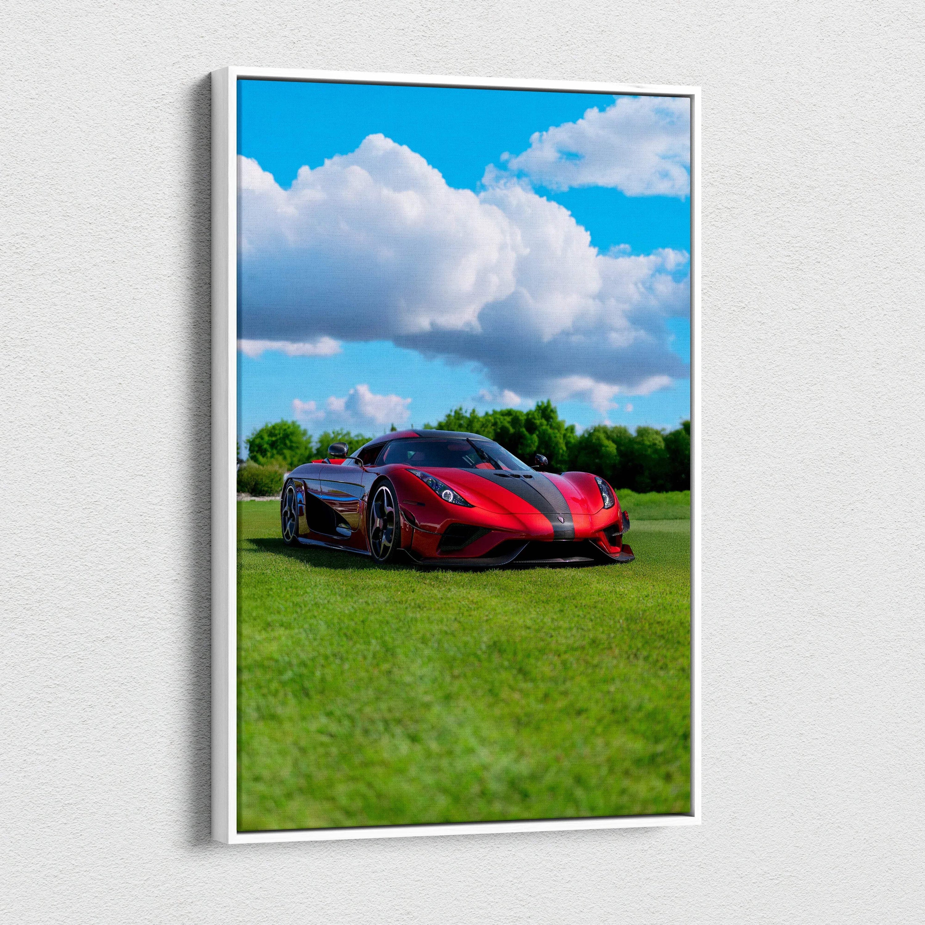 Vertical canvas wall art featuring a red Koenigsegg Regera sports car on grass under a blue sky with clouds.