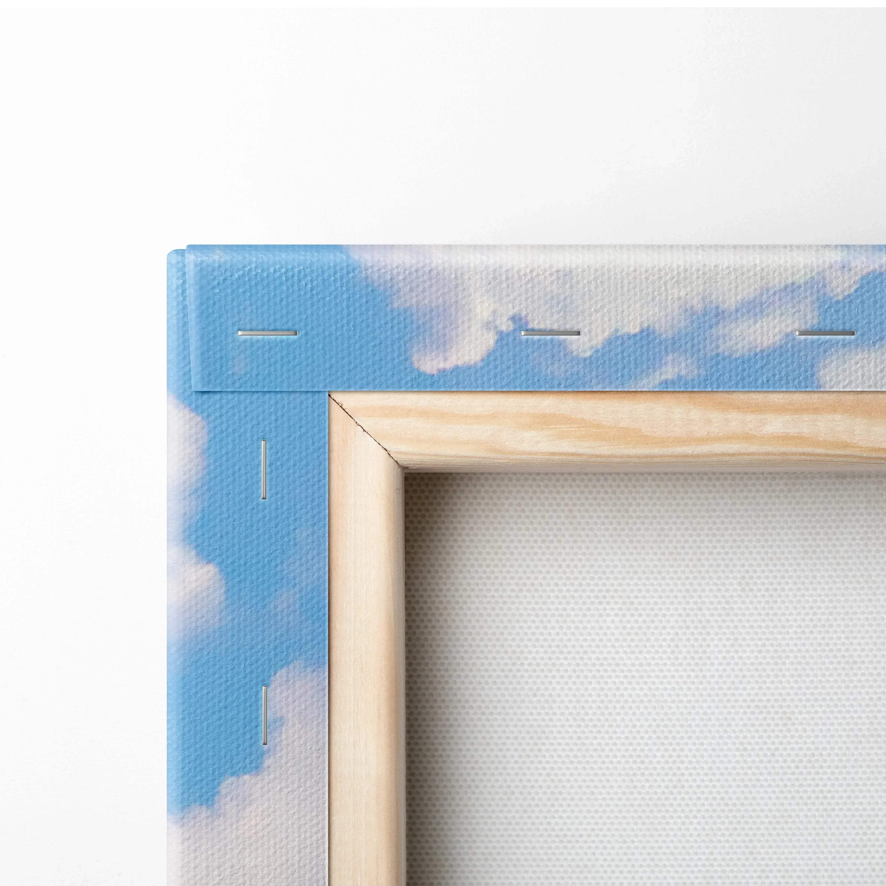 Close-up of wooden frame corner with blue sky and cloud design on vertical canvas wall art.