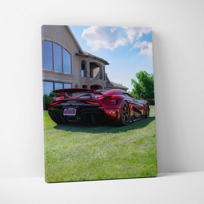 Vertical canvas art of a red Koenigsegg Regera parked on grass in front of a modern house under blue sky.