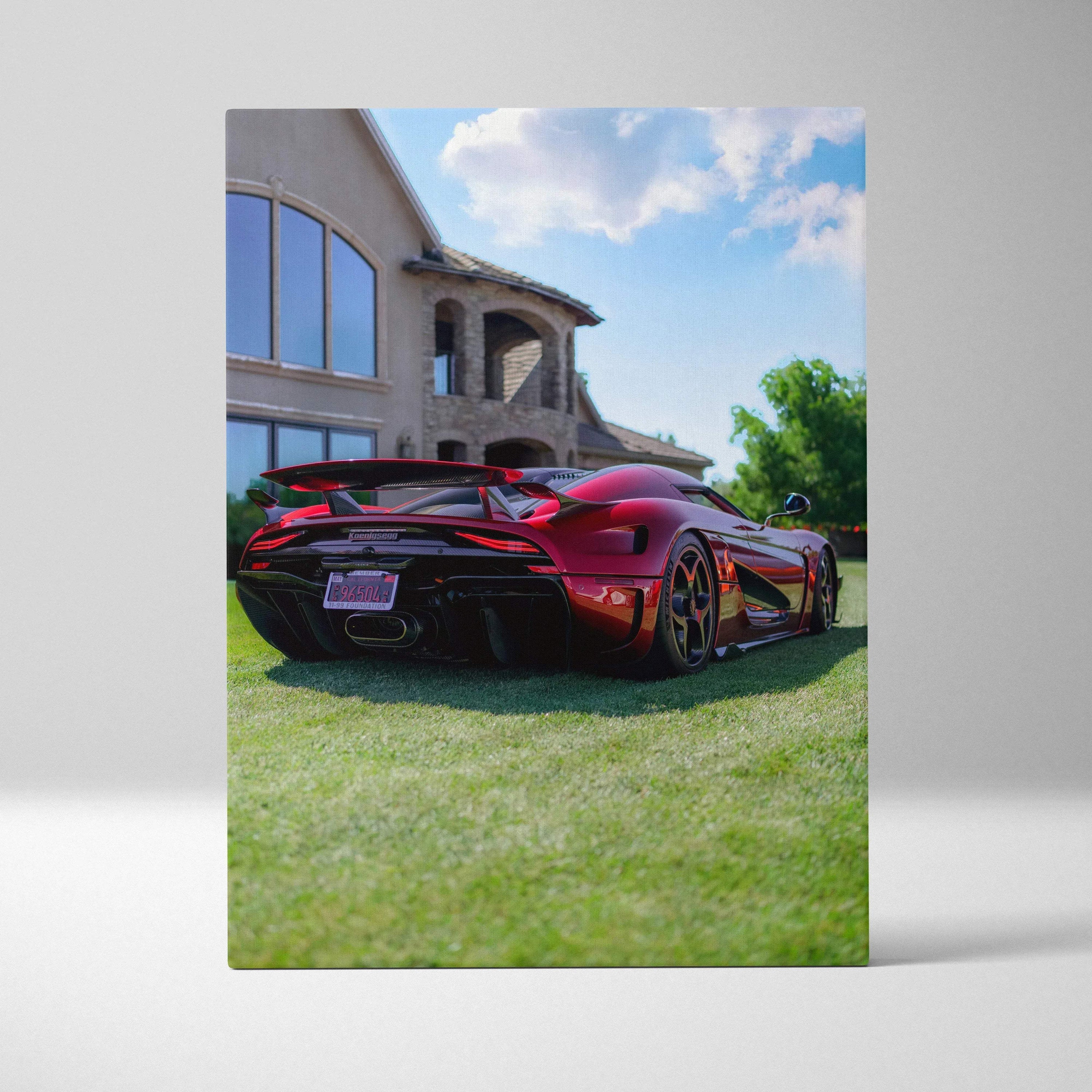 Koenigsegg Regera in glossy red displayed on vertical canvas art with luxury house background and green lawn wall art.