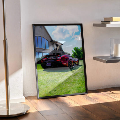 Koenigsegg Regera poster showcasing a red sports car parked by modern glass building, wall art in black frame.