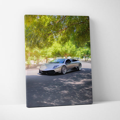 Vertical canvas art featuring a silver Lamborghini Murcielago under green trees, high-resolution wall art.