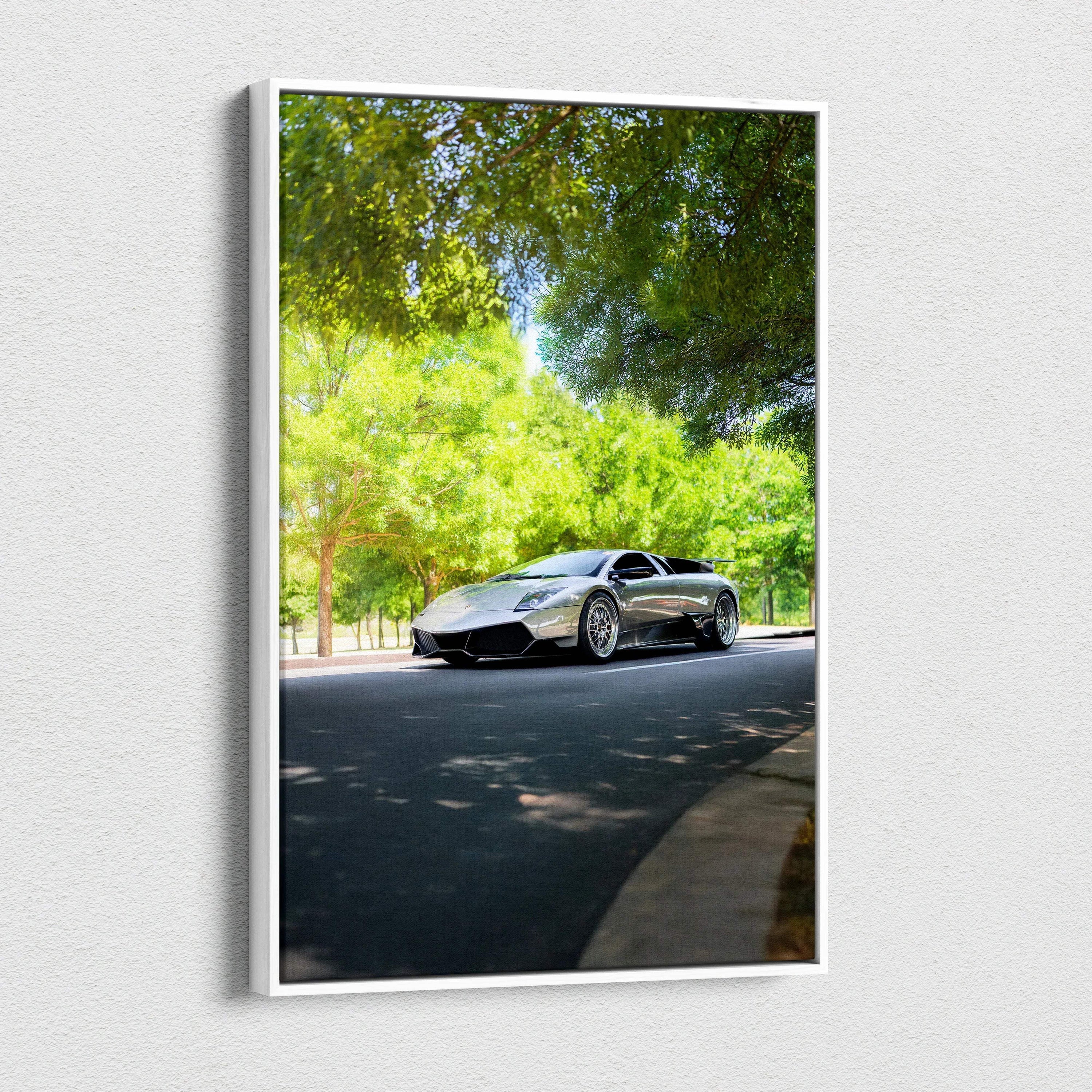 Vertical canvas wall art featuring a sleek black Lamborghini Murcielago on a sunny tree-lined road.