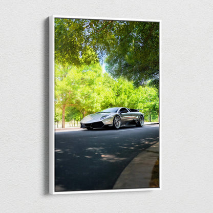 Vertical canvas wall art featuring a sleek black Lamborghini Murcielago on a sunny tree-lined road.