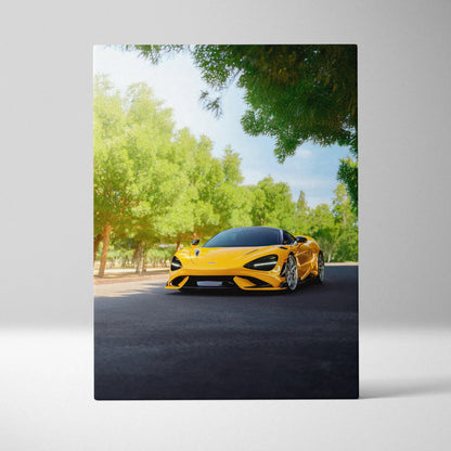 Yellow McLaren 765LT sports car on road surrounded by green trees vertical canvas wall art.