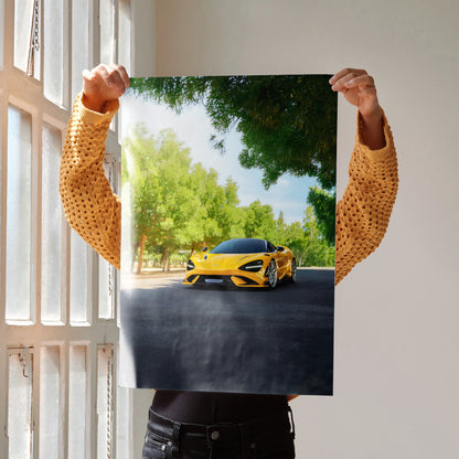McLaren 765LT yellow sports car driving on road poster wall art with green trees and shadows.