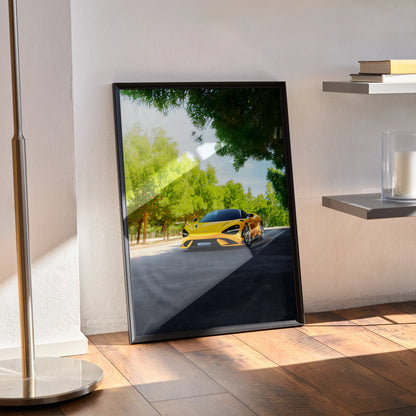 McLaren 765LT yellow sports car poster leaning against wall in black frame wall art.