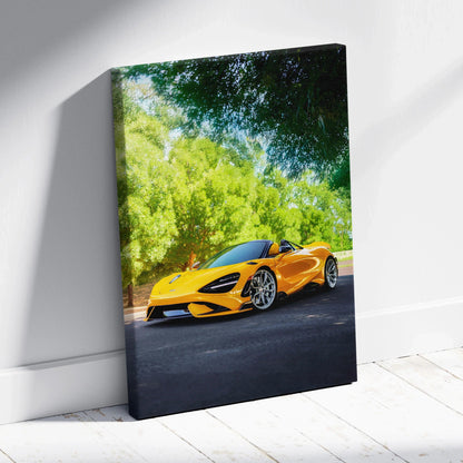 Yellow McLaren 765LT on road with green trees canvas wall art in vertical format.