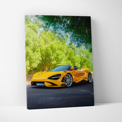 Vertical canvas wall art featuring a vivid yellow McLaren 765LT sports car against a lush green background.