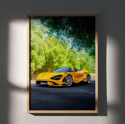 McLaren 765LT bright orange sports car poster with lush green trees background wall art in wooden frame.