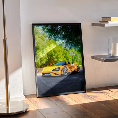 McLaren 765LT yellow sports car poster leaning against wall with sunlight and greenery background wall art.