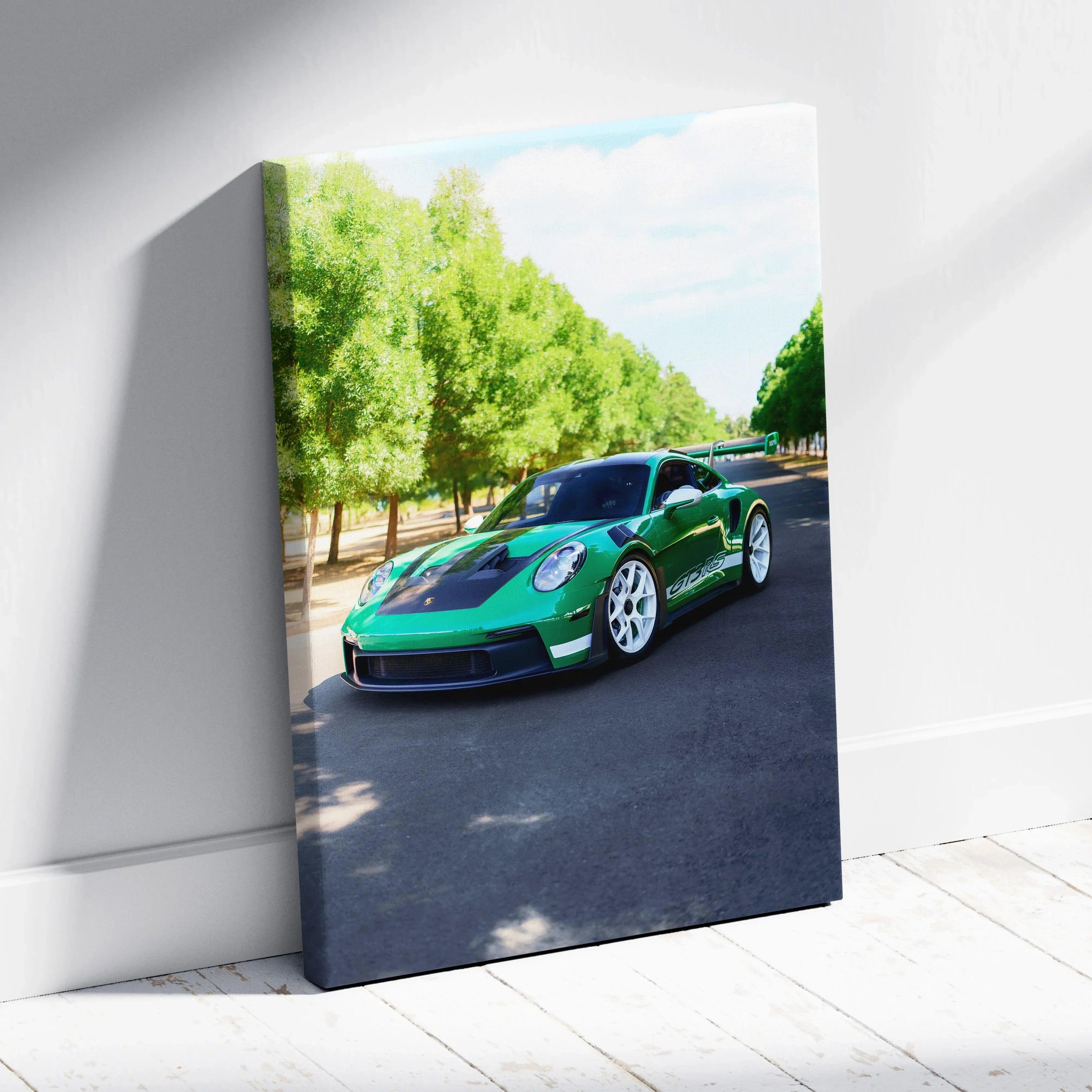 Porsche 911 GT3 RS green sports car driving on tree-lined road canvas wall art.