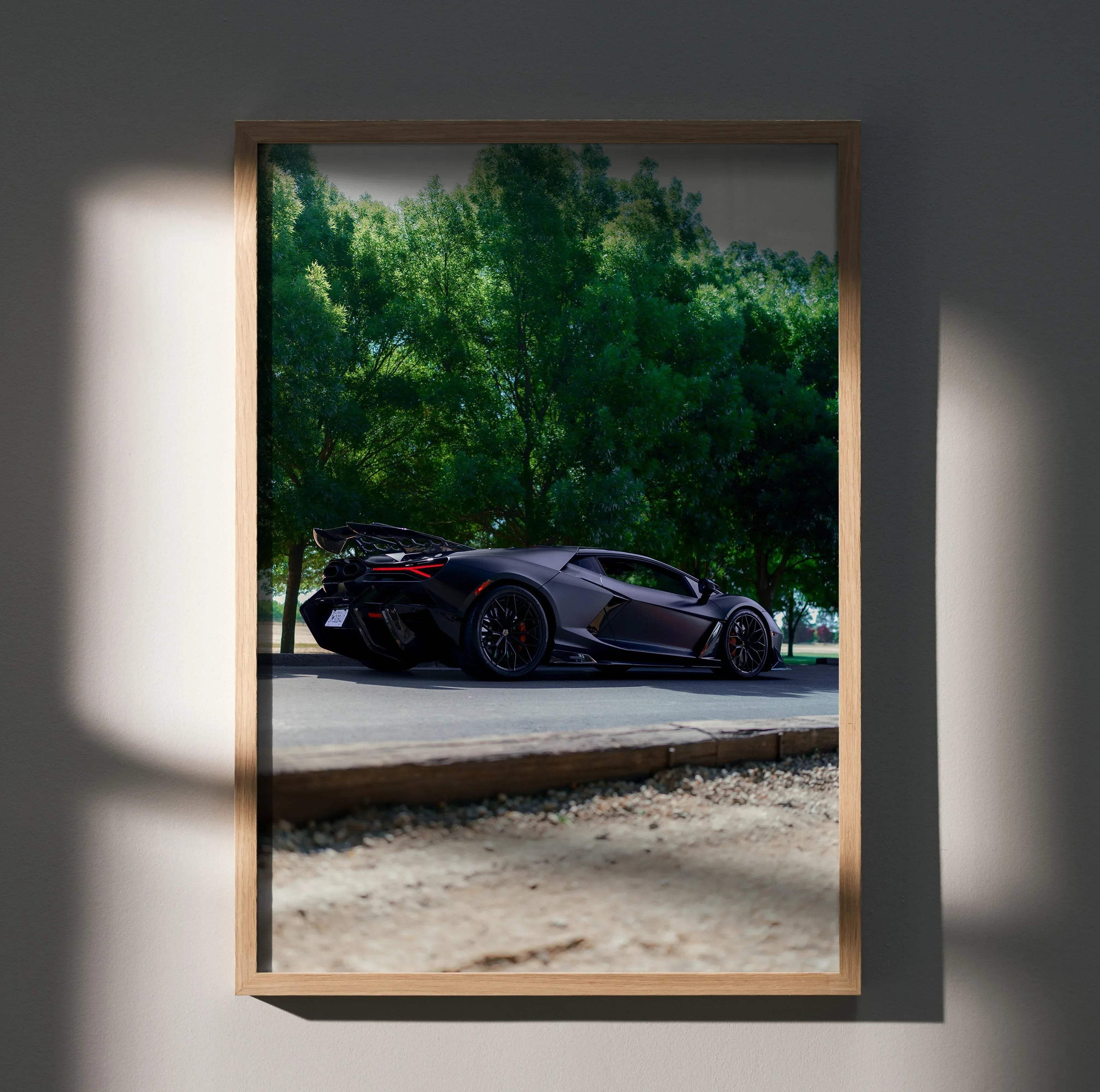 Lamborghini Revuelto black sports car poster wall art with green trees background.