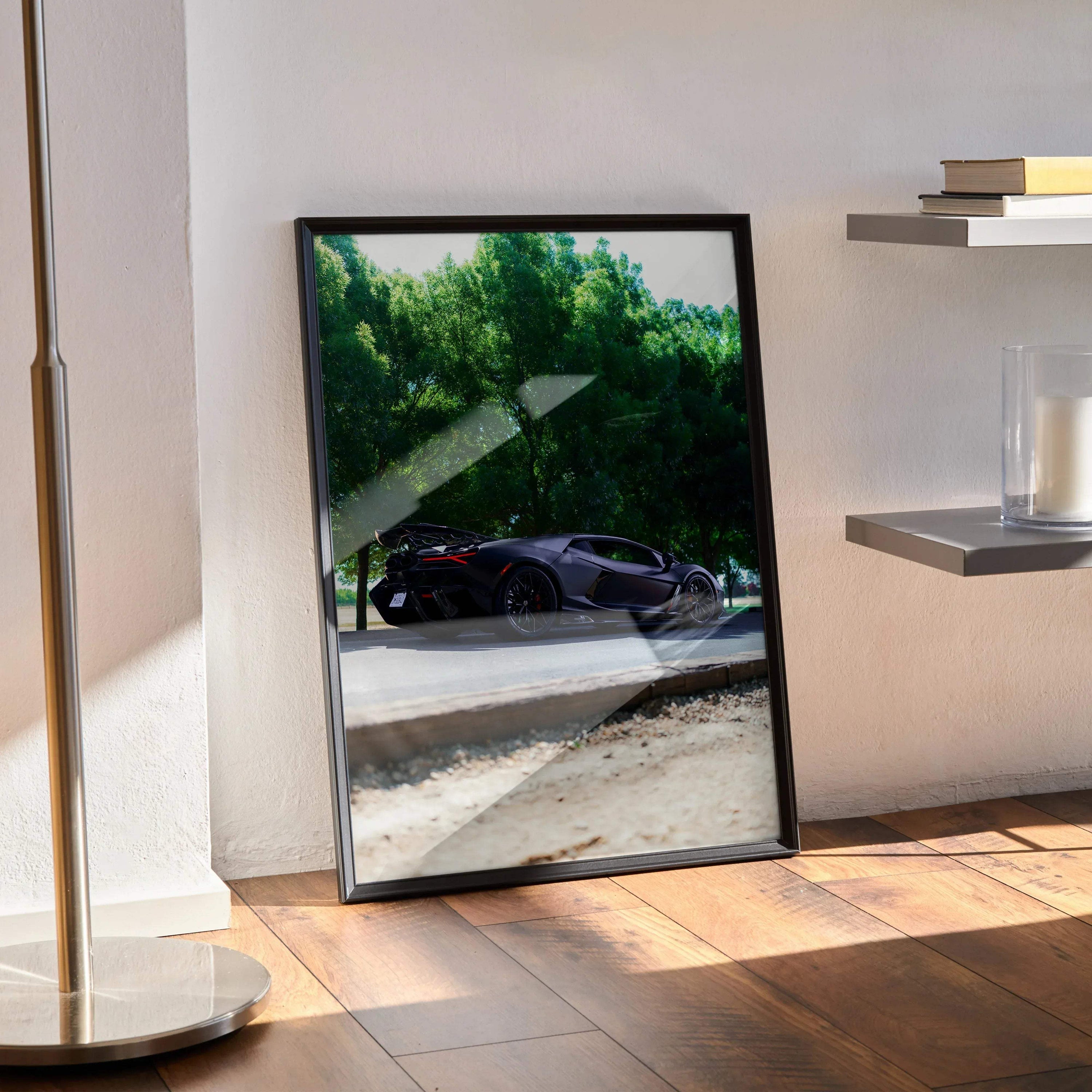 Lamborghini Revuelto poster featuring black sports car against green trees, modern wall art in black frame.