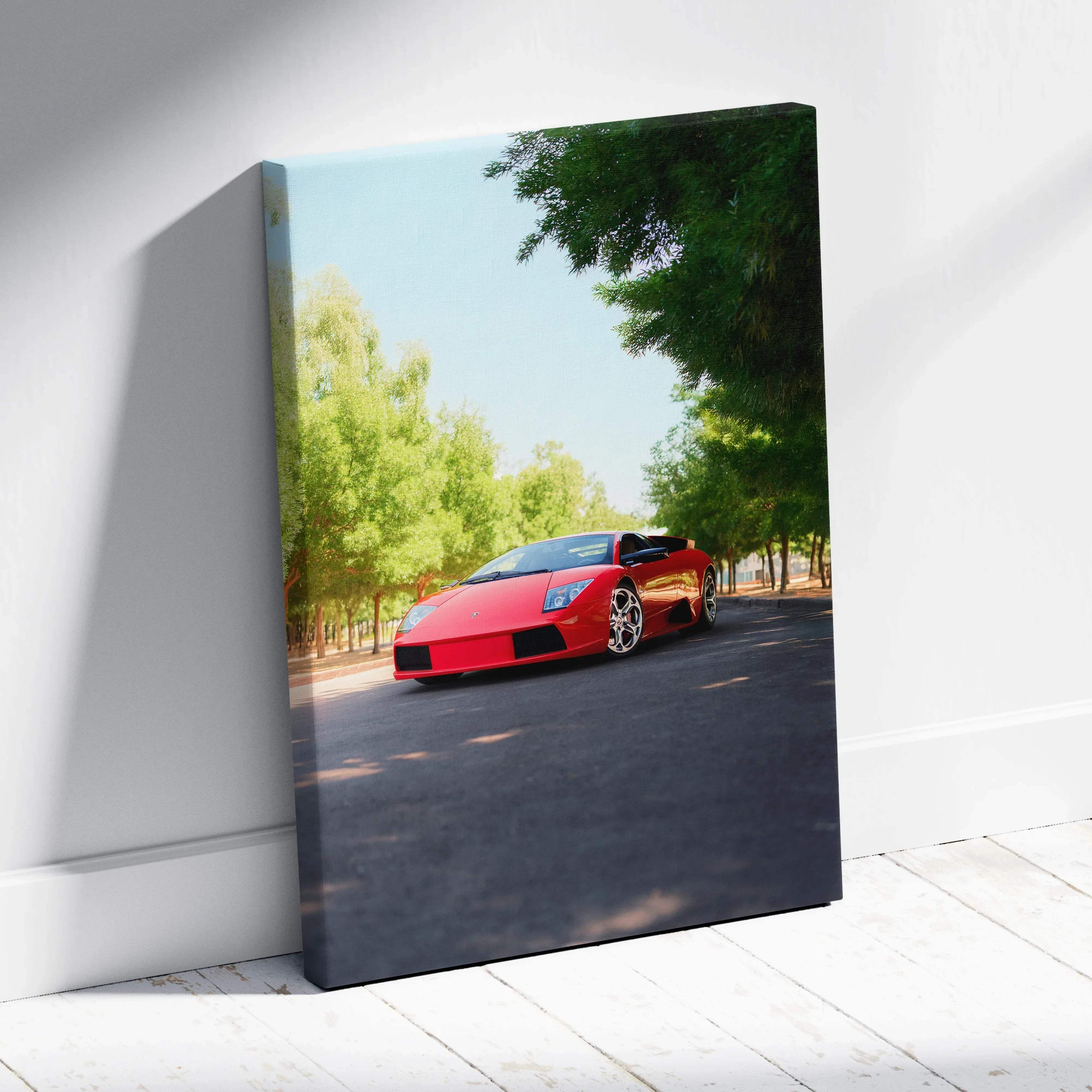 Red Lamborghini Murcielago vertical canvas wall art featuring a sleek sports car on a tree-lined road print