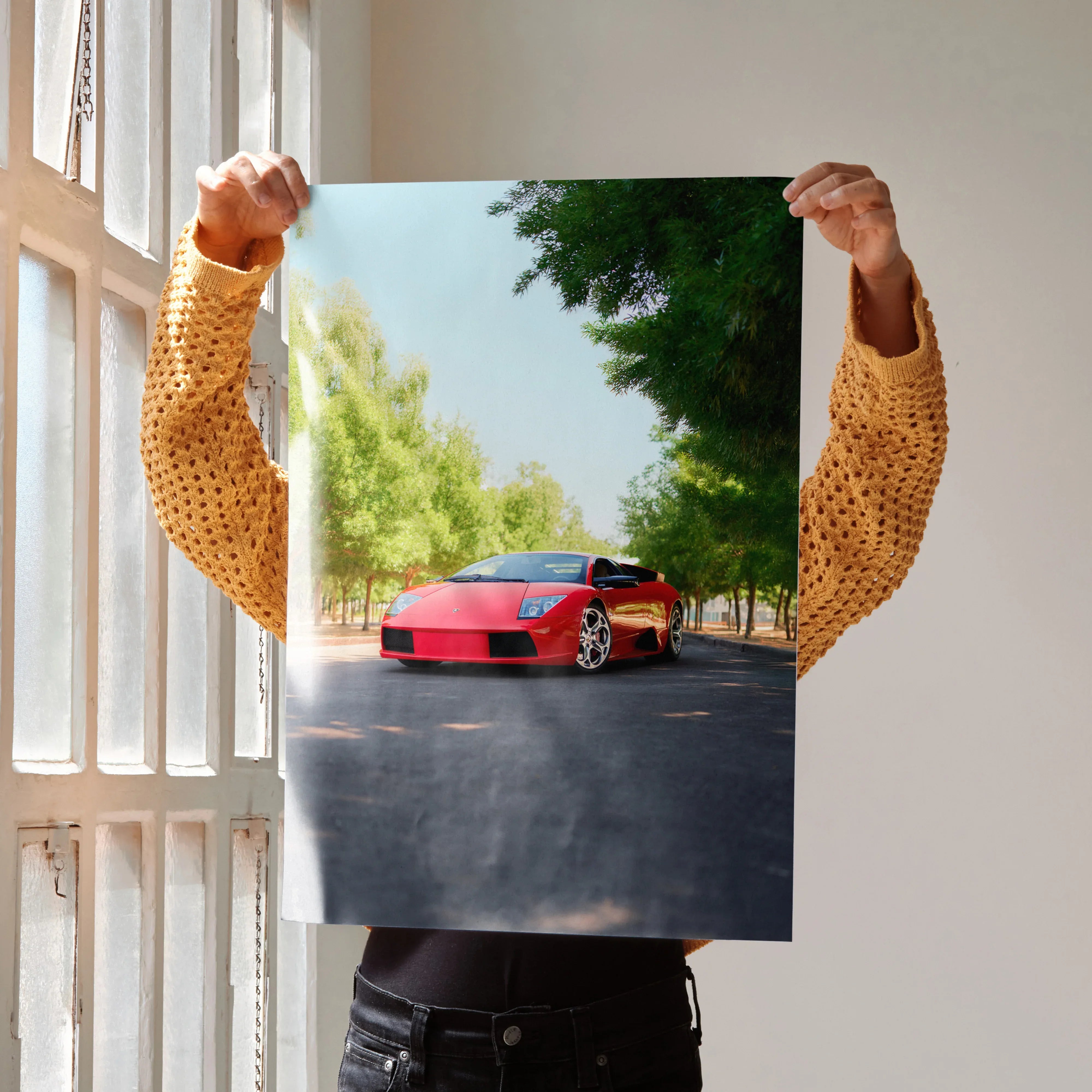 Lamborghini Murcielago poster showing red sports car on tree-lined road as wall art.