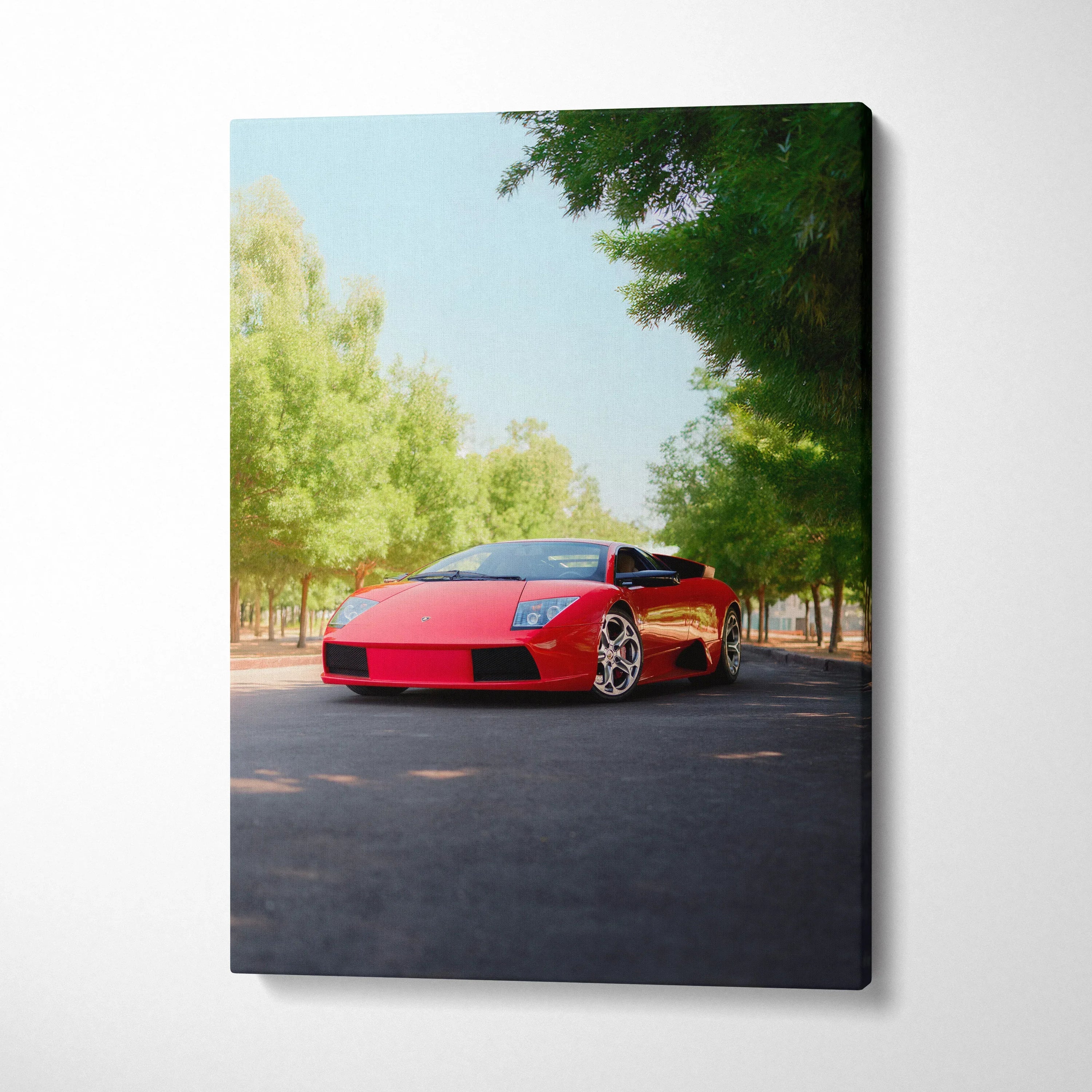Vertical canvas wall art featuring a red Lamborghini Murcielago on a tree-lined road.