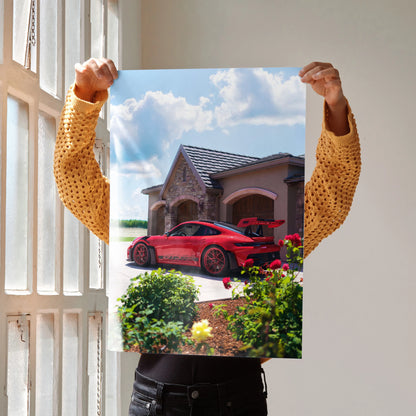 Porsche 911 GT3 RS parked outside rustic house, vibrant red car poster wall art.