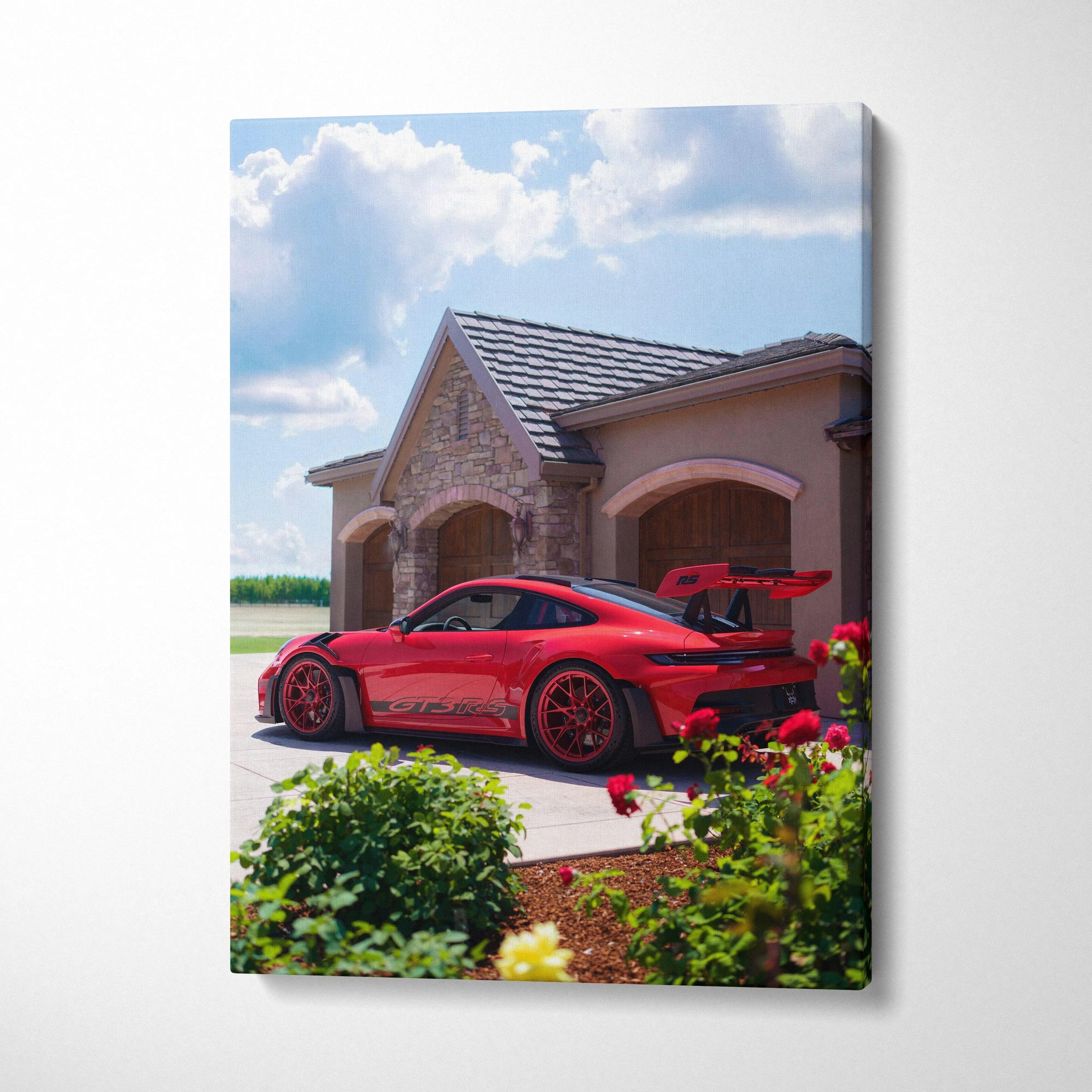 Vertical canvas art featuring a red Porsche 911 GT3 RS parked by stone luxury home under blue sky.