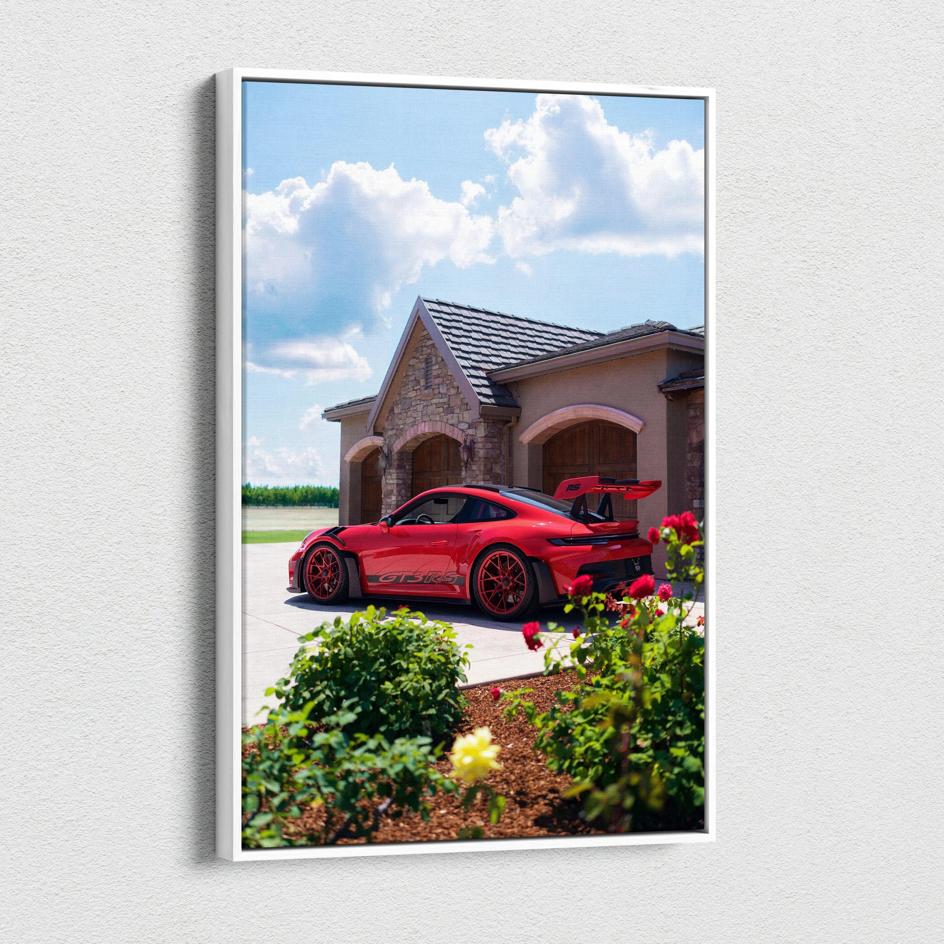 Vertical canvas art featuring a red Porsche 911 GT3 RS parked by a house under a blue sky with clouds.