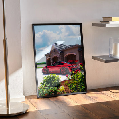 Porsche 911 GT3 RS red sports car poster leaning against wall with house background wall art.