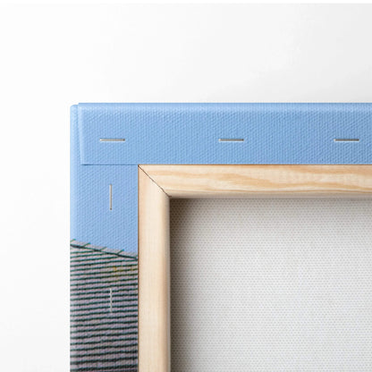 Close-up of wooden frame and blue canvas backing on vertical canvas wall art.