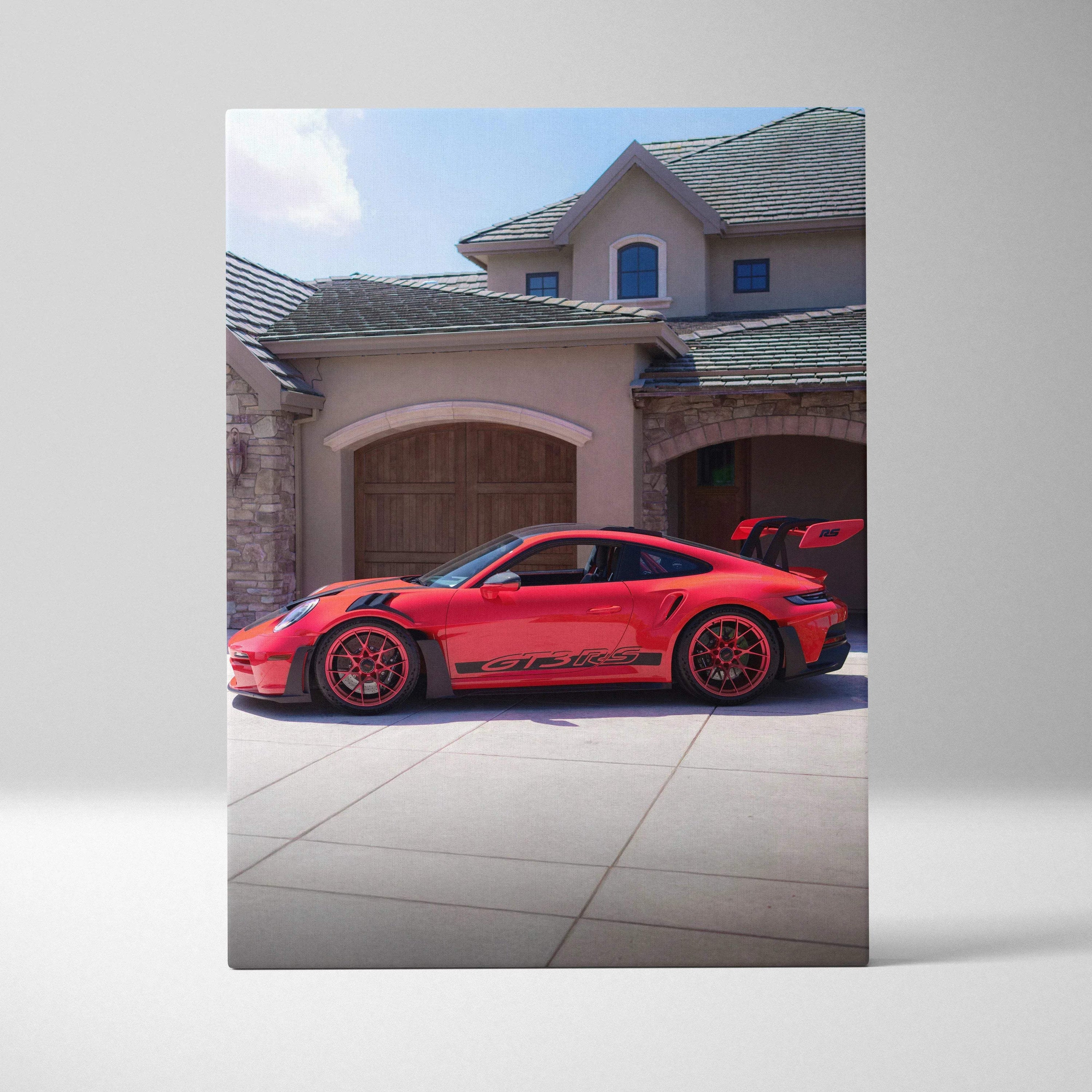 Red Porsche 911 GT3 RS canvas art with black accents in front of luxury home wall art.