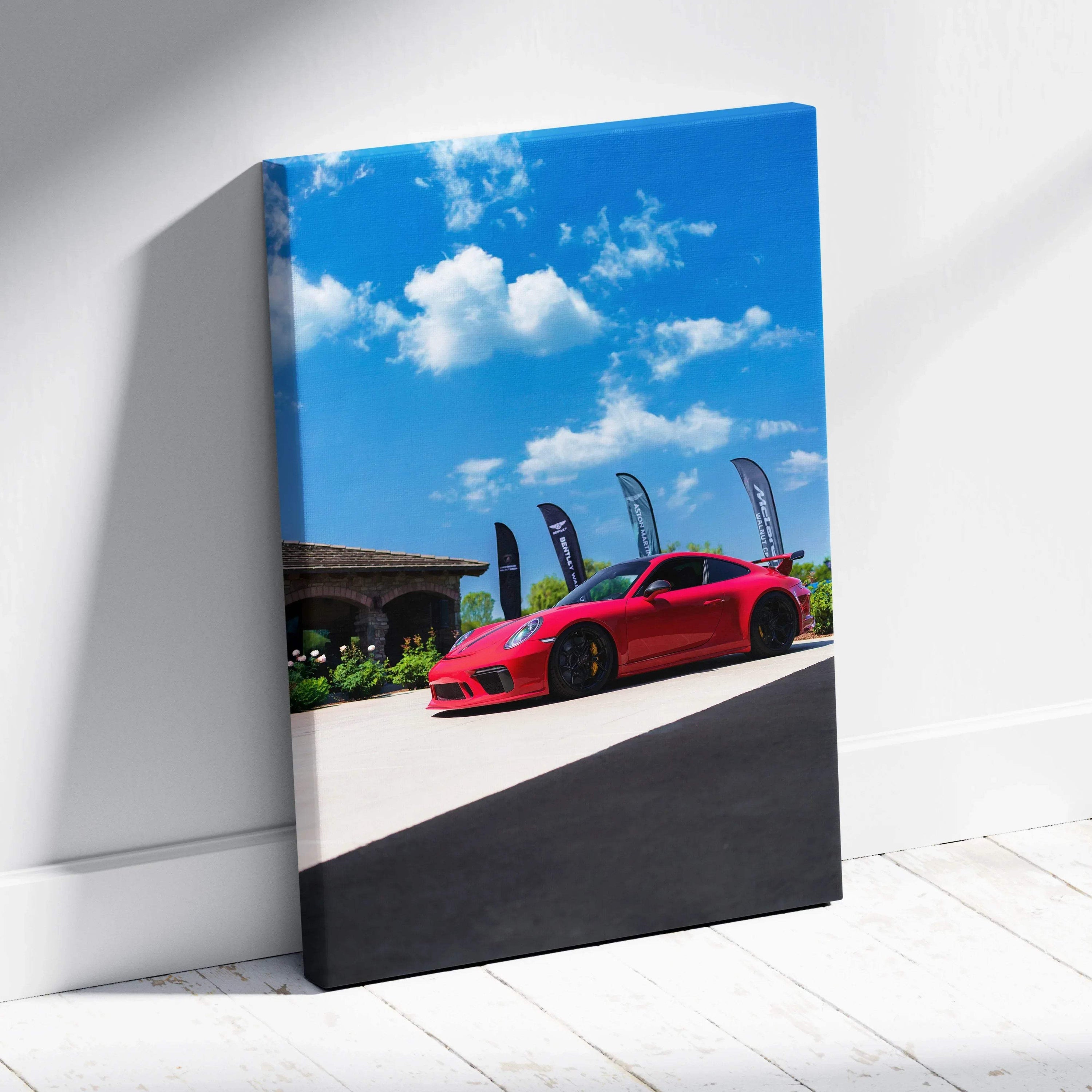 Vertical canvas art of a red Porsche 911 GT3 parked under a blue sky with clouds, modern wall art.