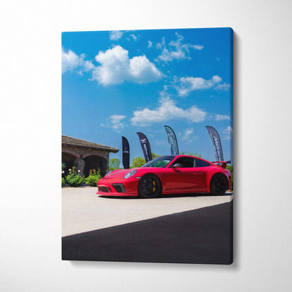 Red Porsche 911 GT3 parked outside under blue sky canvas wall art print.