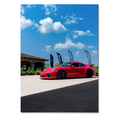 Red Porsche 911 GT3 parked under blue sky, high-resolution poster wall art with vibrant colors.