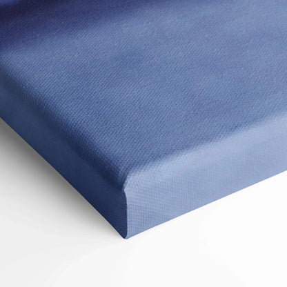 Close-up of blue textured canvas stretched over wooden frame for wall art display.