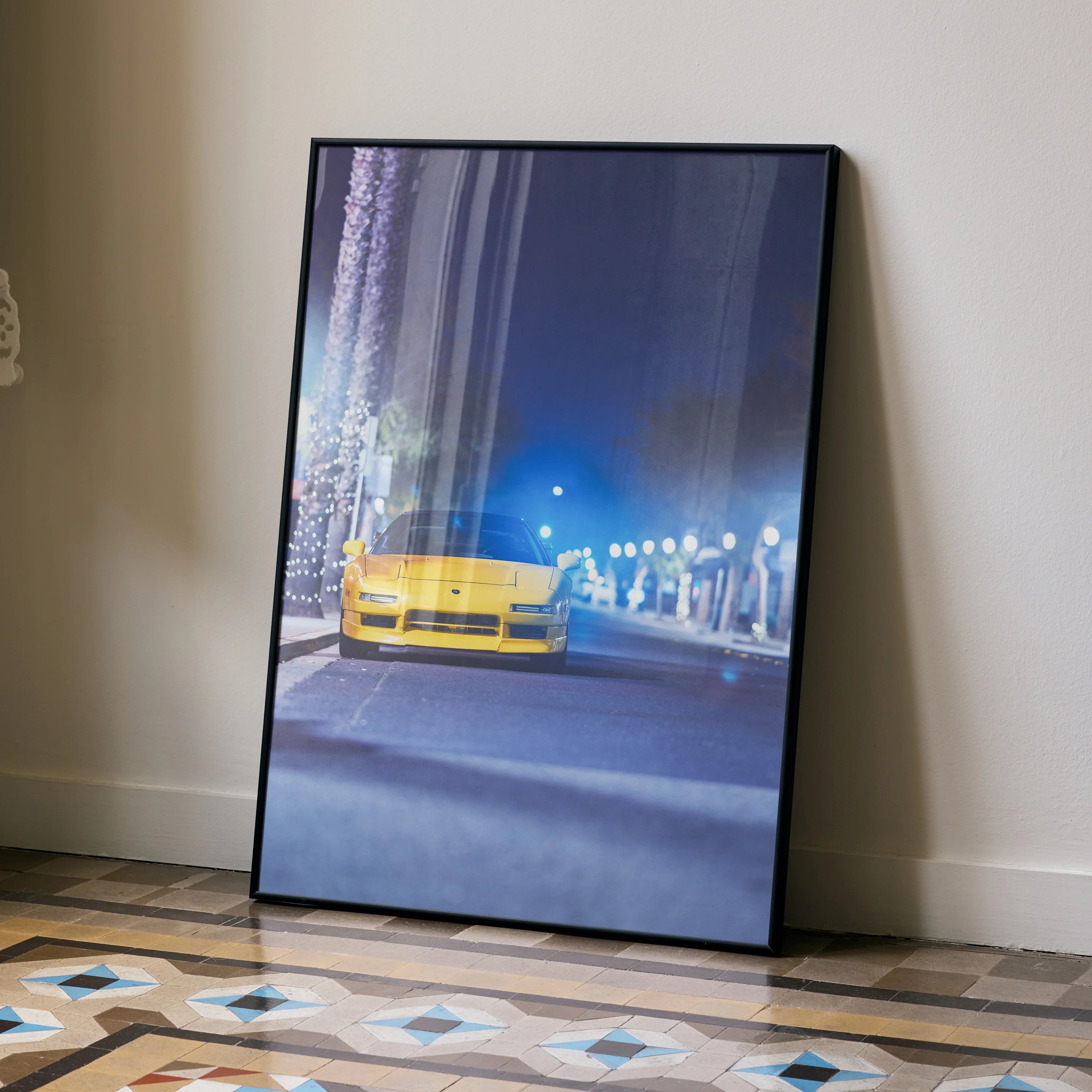 Yellow Acura NSX driving at night in city street poster wall art with black frame.