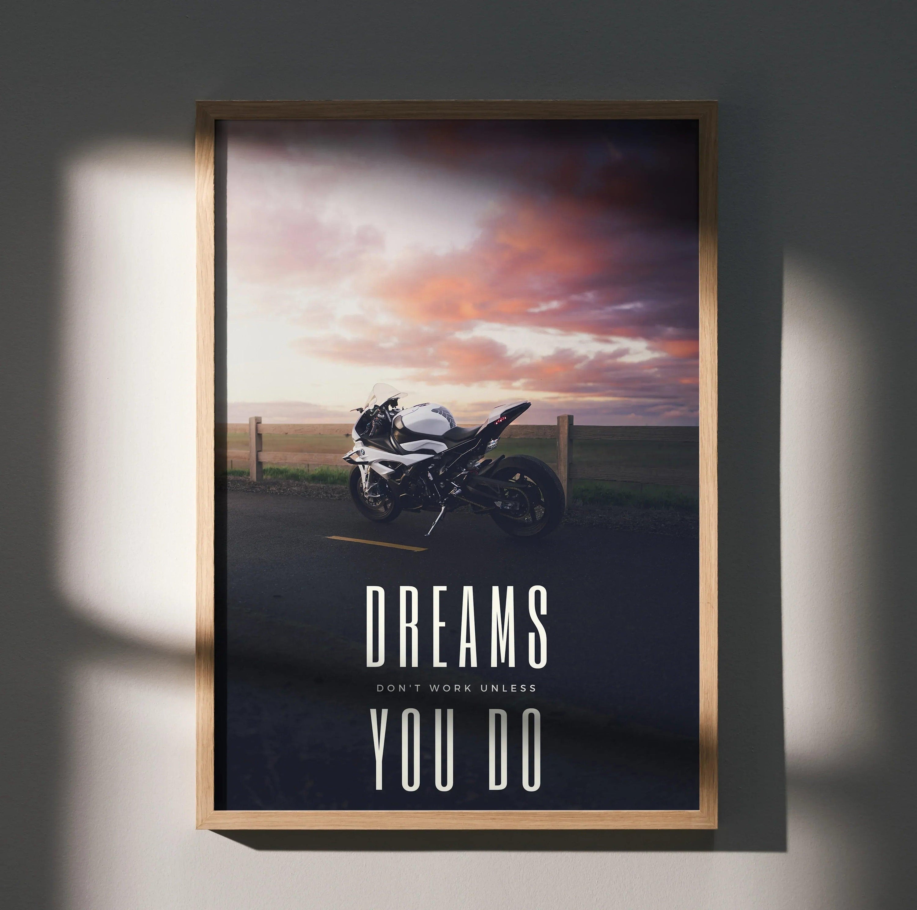 Motivational poster wall art featuring BMW S1000RR motorcycle at sunset with "Dreams Don't Work Unless You Do" text.