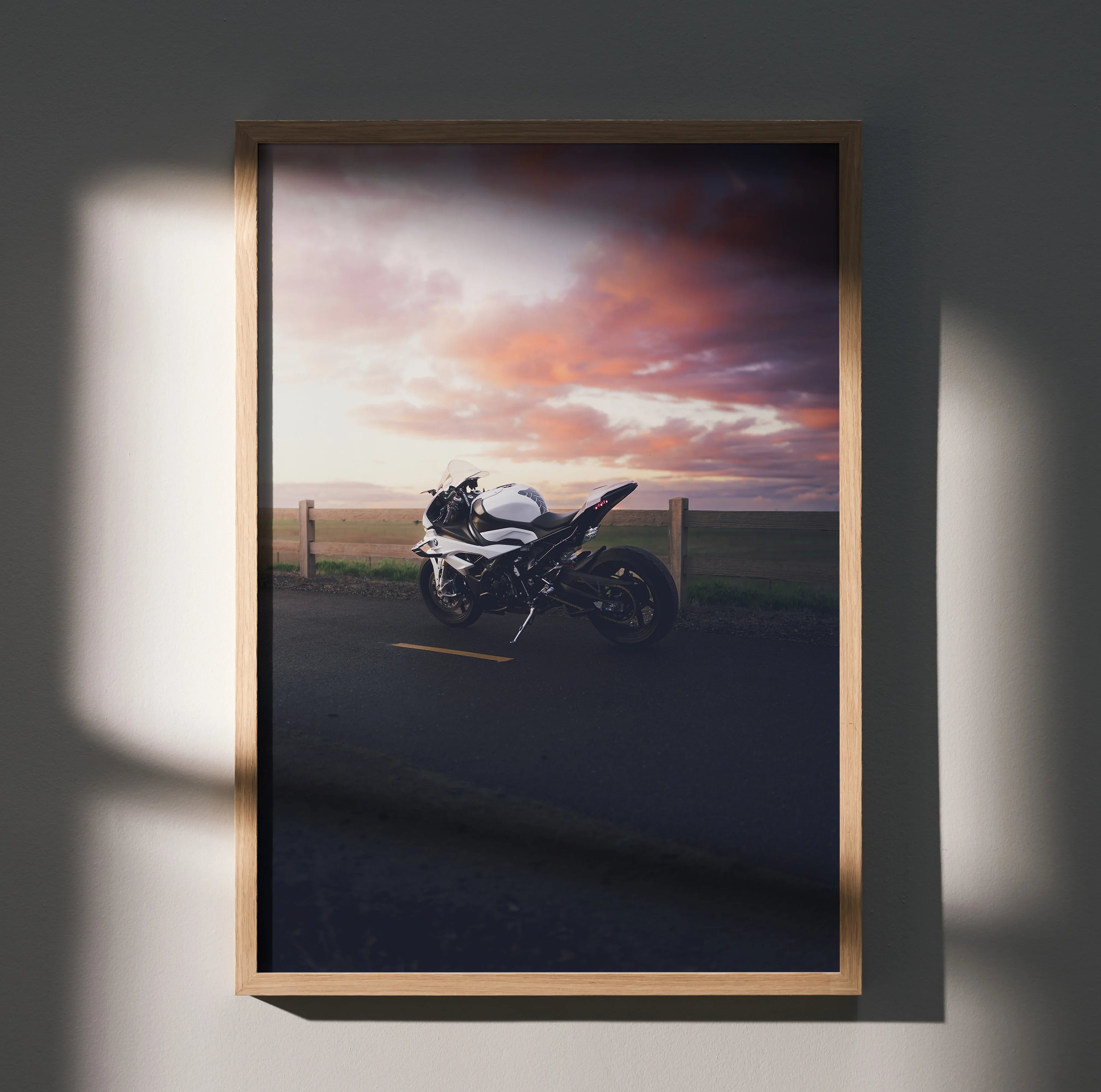 BMW S1000RR motorcycle poster with sunset sky, framed wall art in natural wood frame.