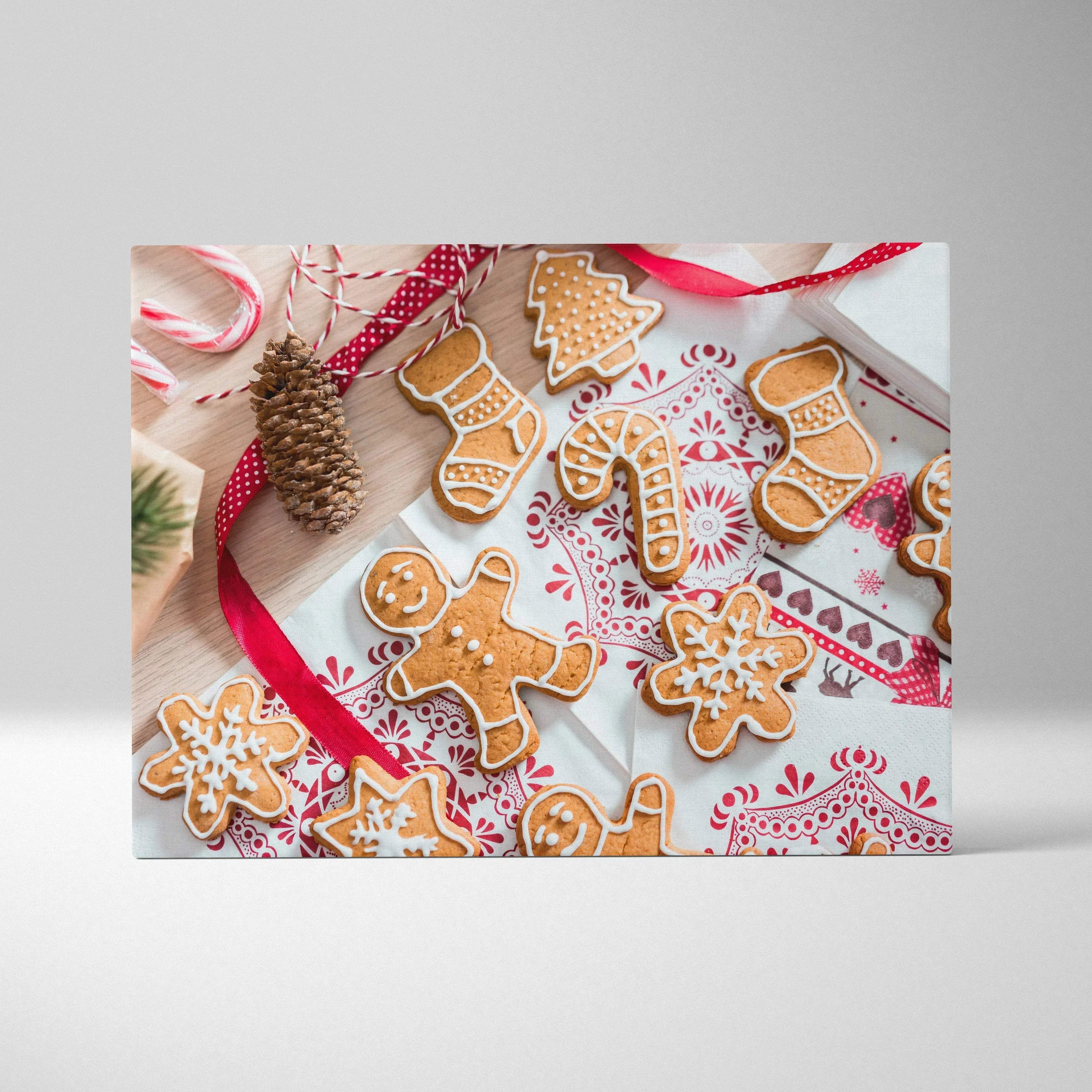 Canvas wall art featuring festive gingerbread cookies decorated with white icing on a red and white patterned background.