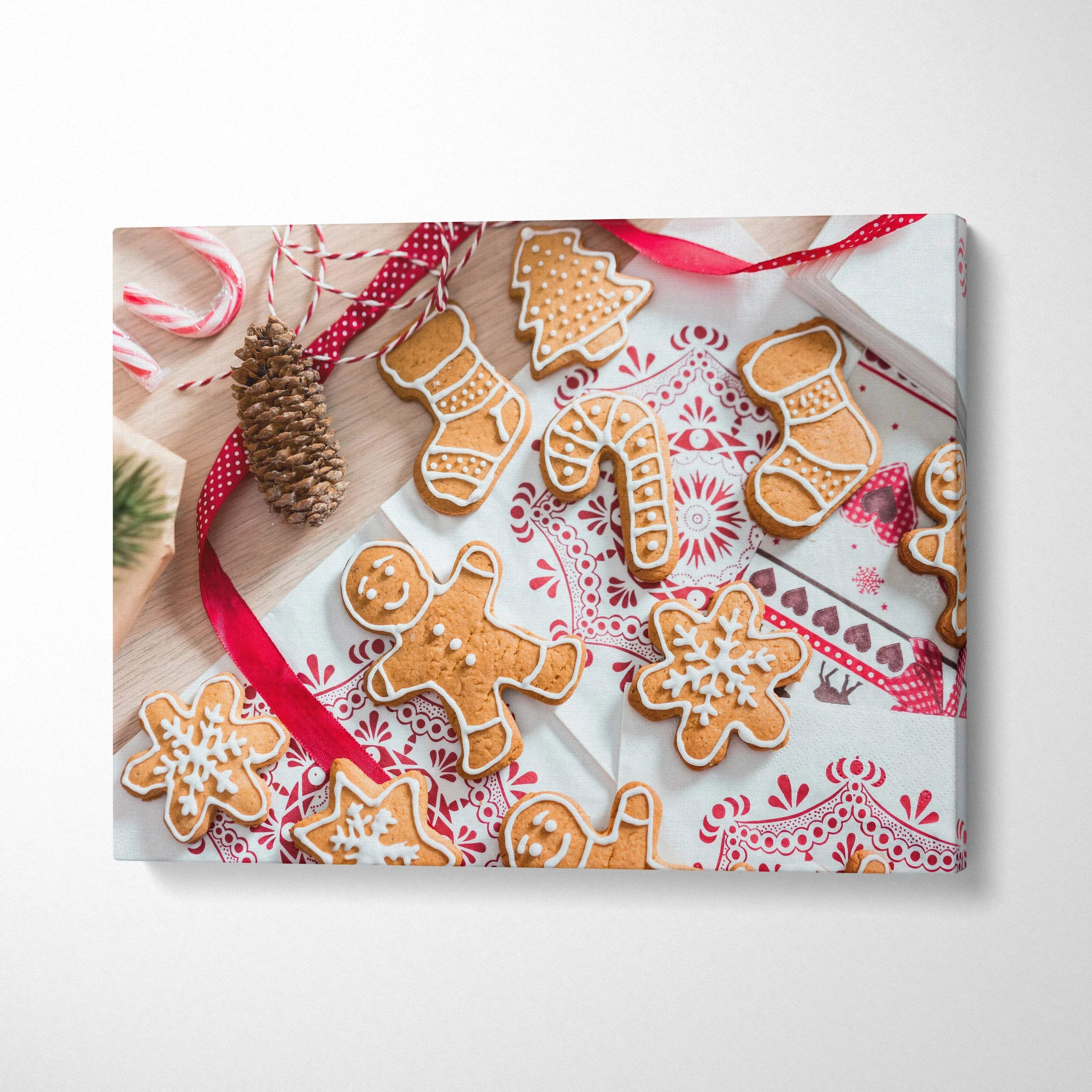 Canvas wall art featuring festive gingerbread cookies, candy canes, and holiday décor on patterned fabric background.