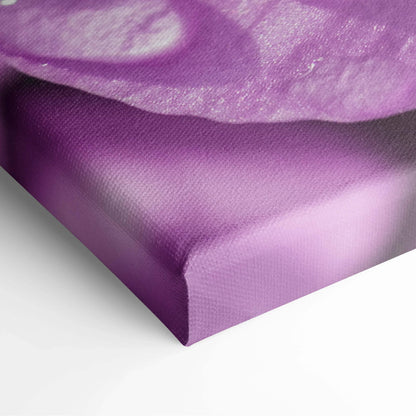Close-up of purple canvas wall art featuring detailed cherry blossom petals with vibrant color tones and texture.