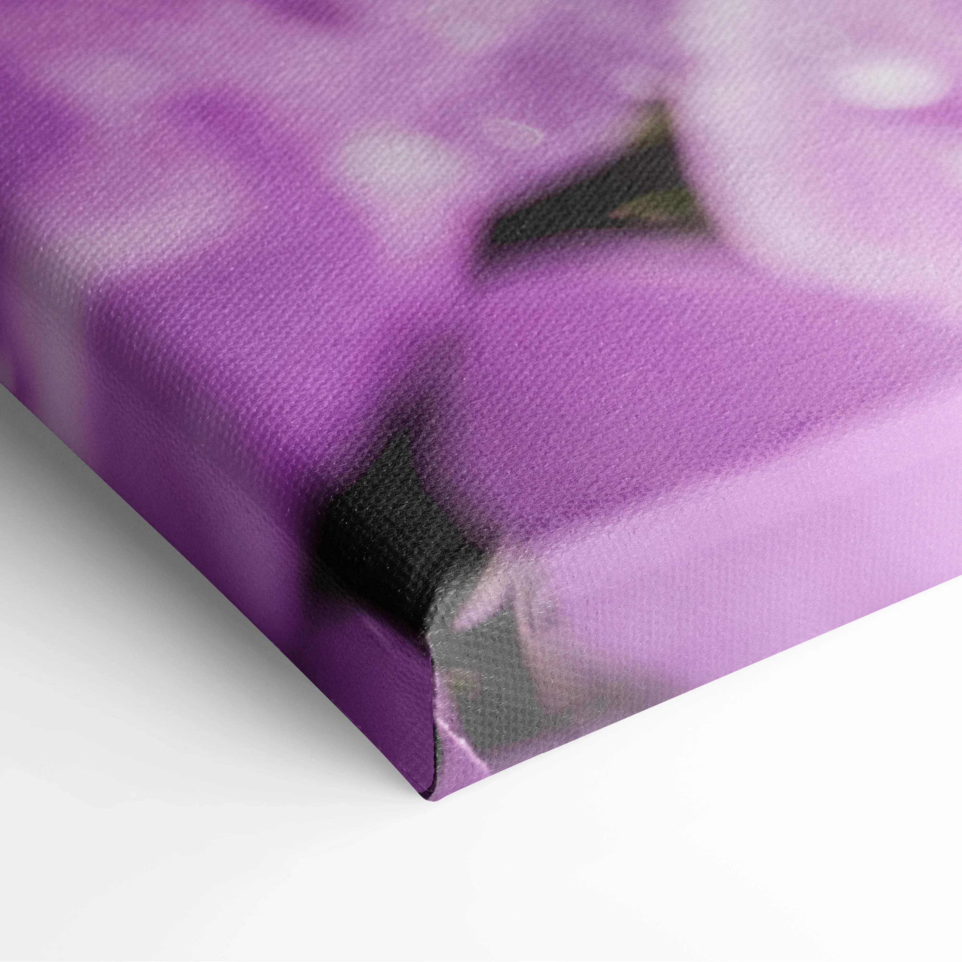 Purple floral canvas wall art featuring macro photography of blooming purple flowers on textured fabric surface