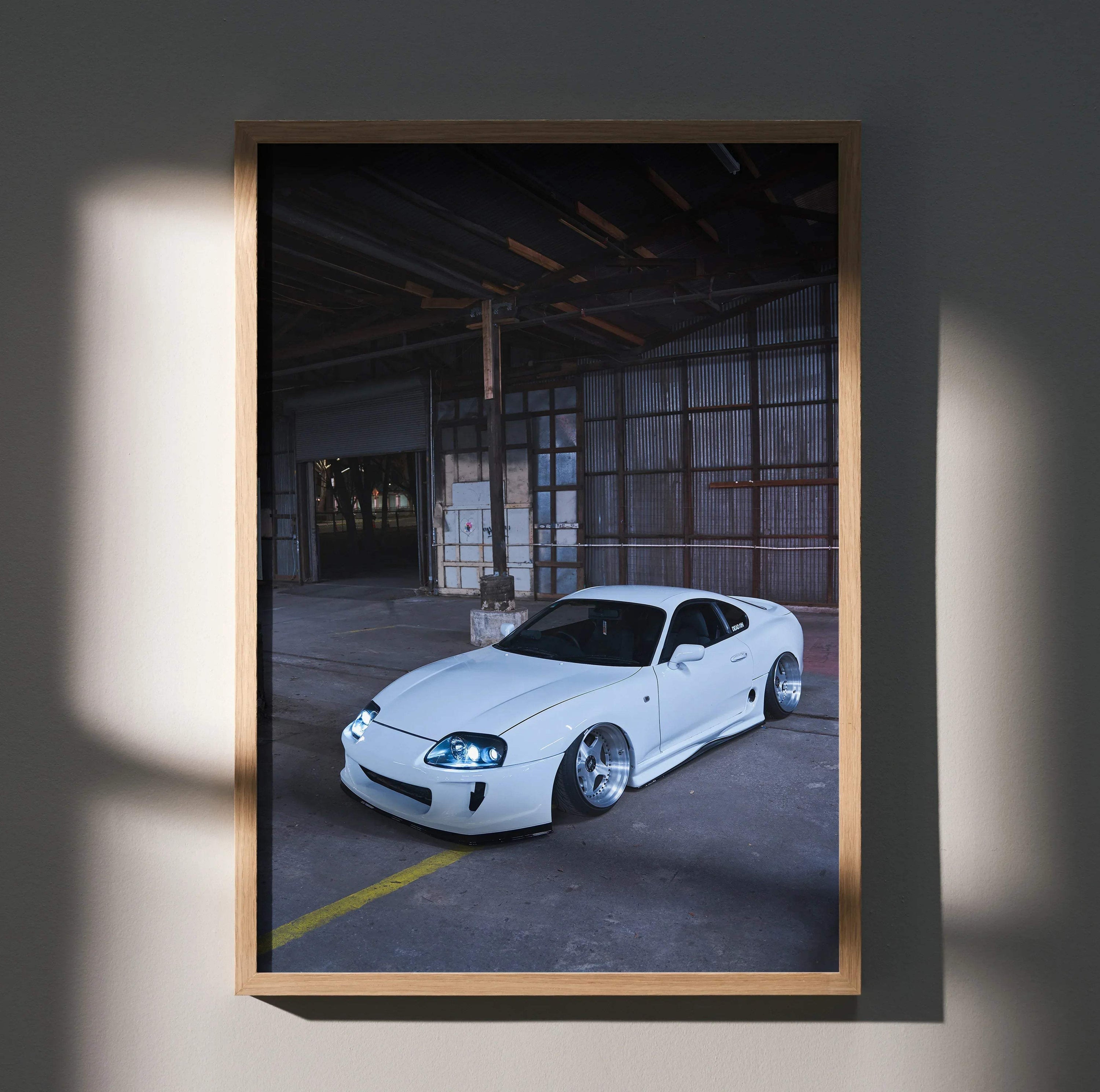 White Toyota Supra MK4 parked in industrial warehouse setting poster wall art.