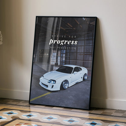 Motivational poster wall art featuring a white Toyota Supra Mk4 in an industrial setting with text "Trust Progress Not.