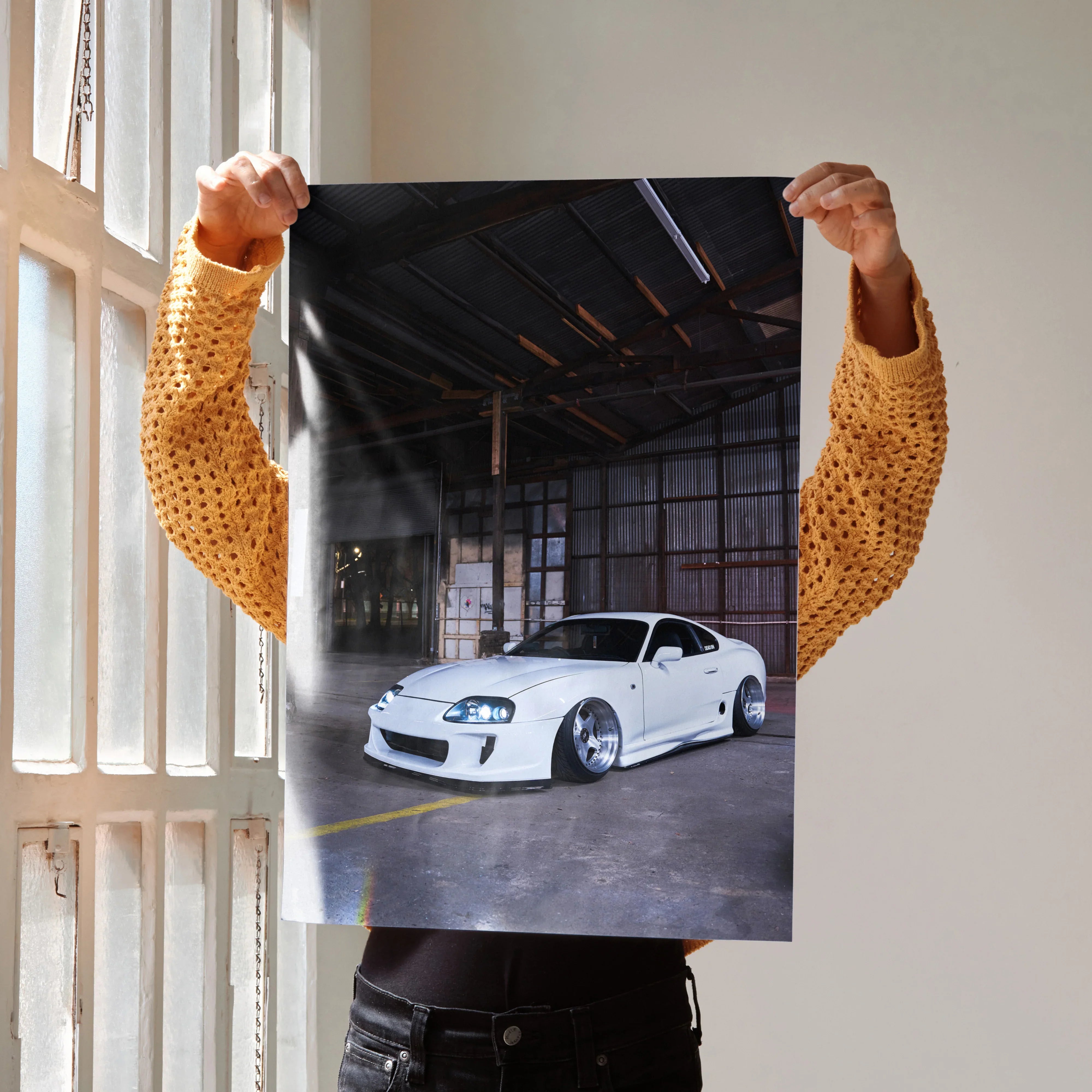 Toyota Supra MK4 white sports car poster held indoors, high detail automotive wall art.