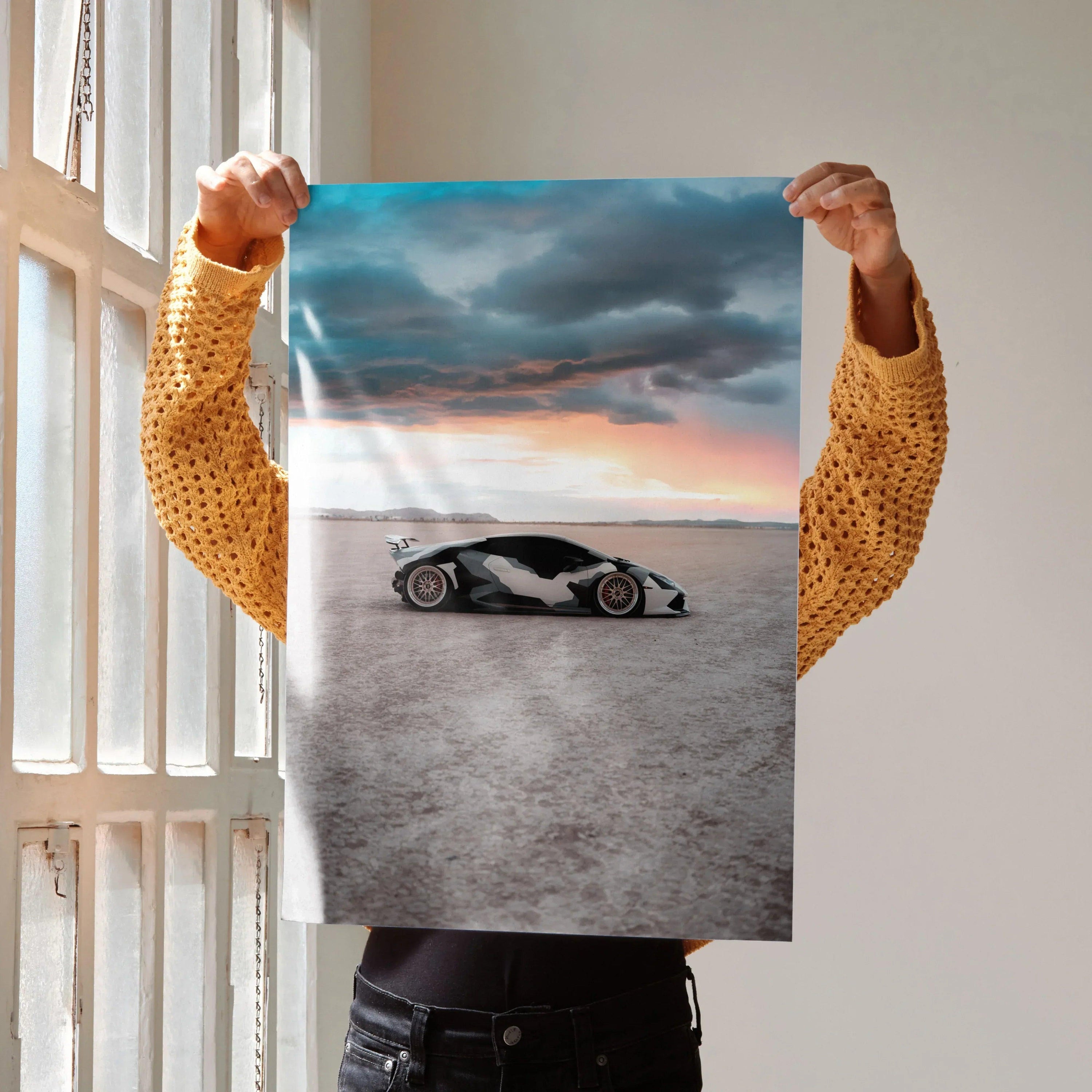 Lamborghini Huracan poster showing sleek black and white sports car under dramatic cloudy sky wall art.