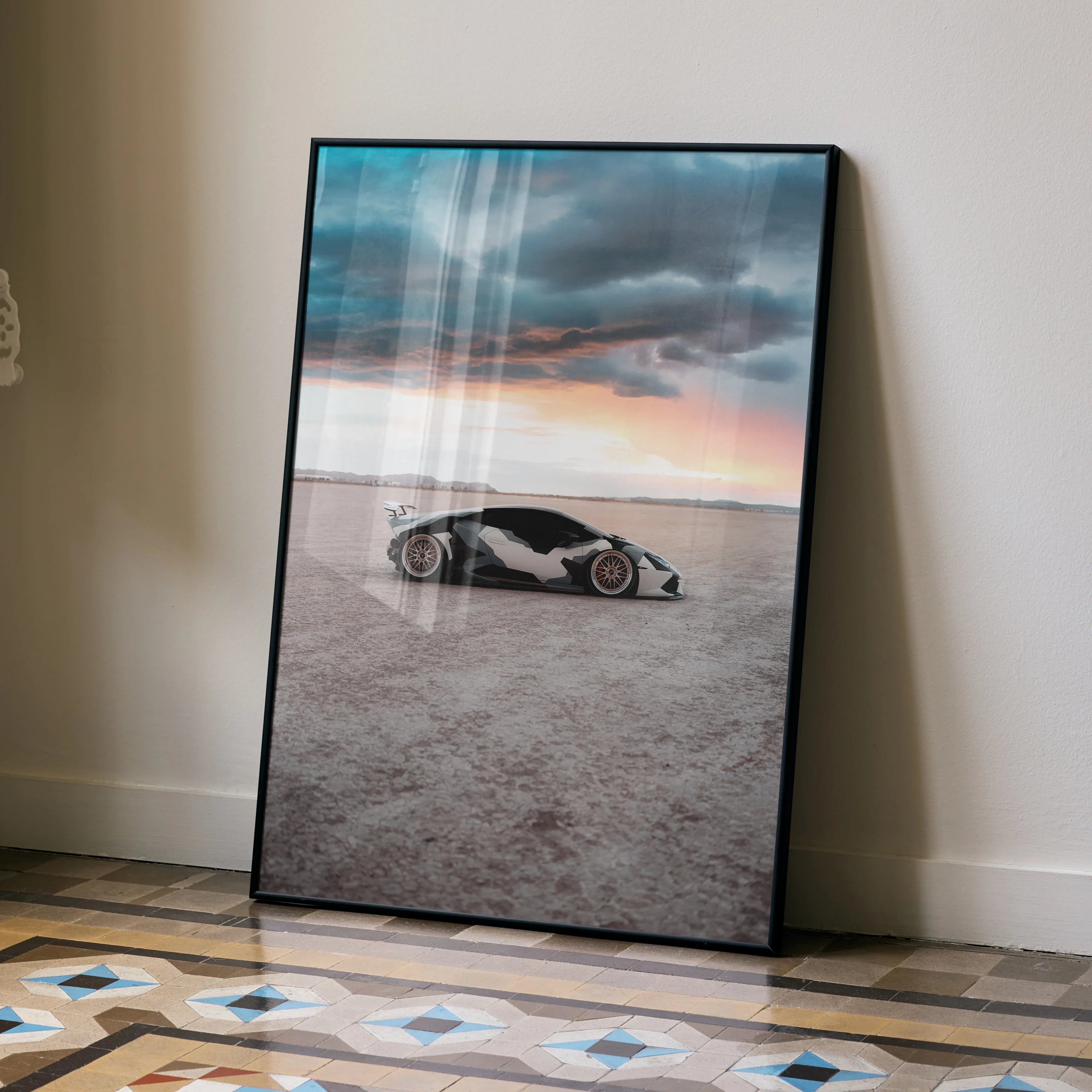 Lamborghini Huracan poster featuring sleek car on desert landscape under dramatic sky, wall art display.