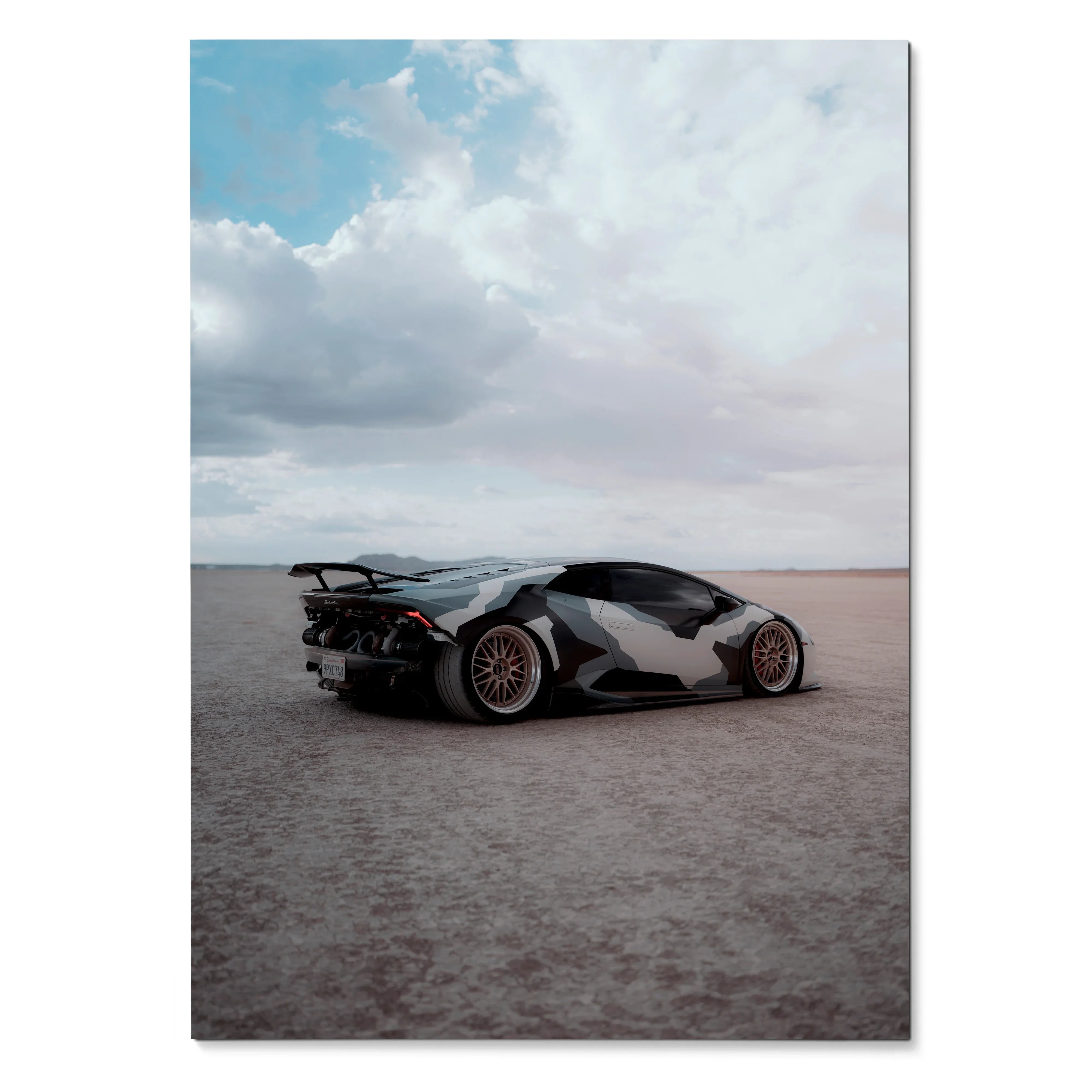 Lamborghini Huracan sports car on desert road poster wall art with dramatic cloudy sky.