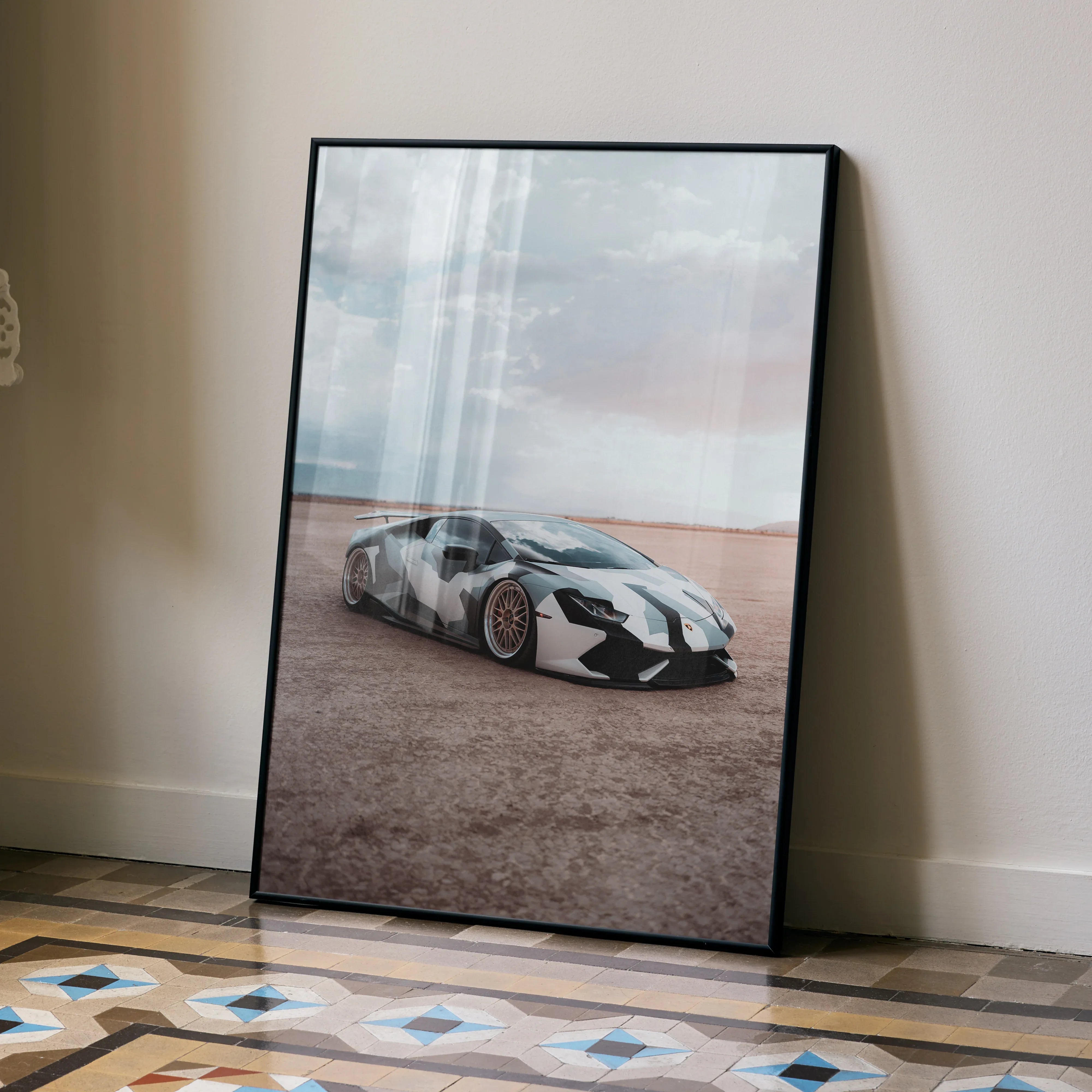 Lamborghini Huracan poster with black and white car on desert background, stylish wall art in black frame.