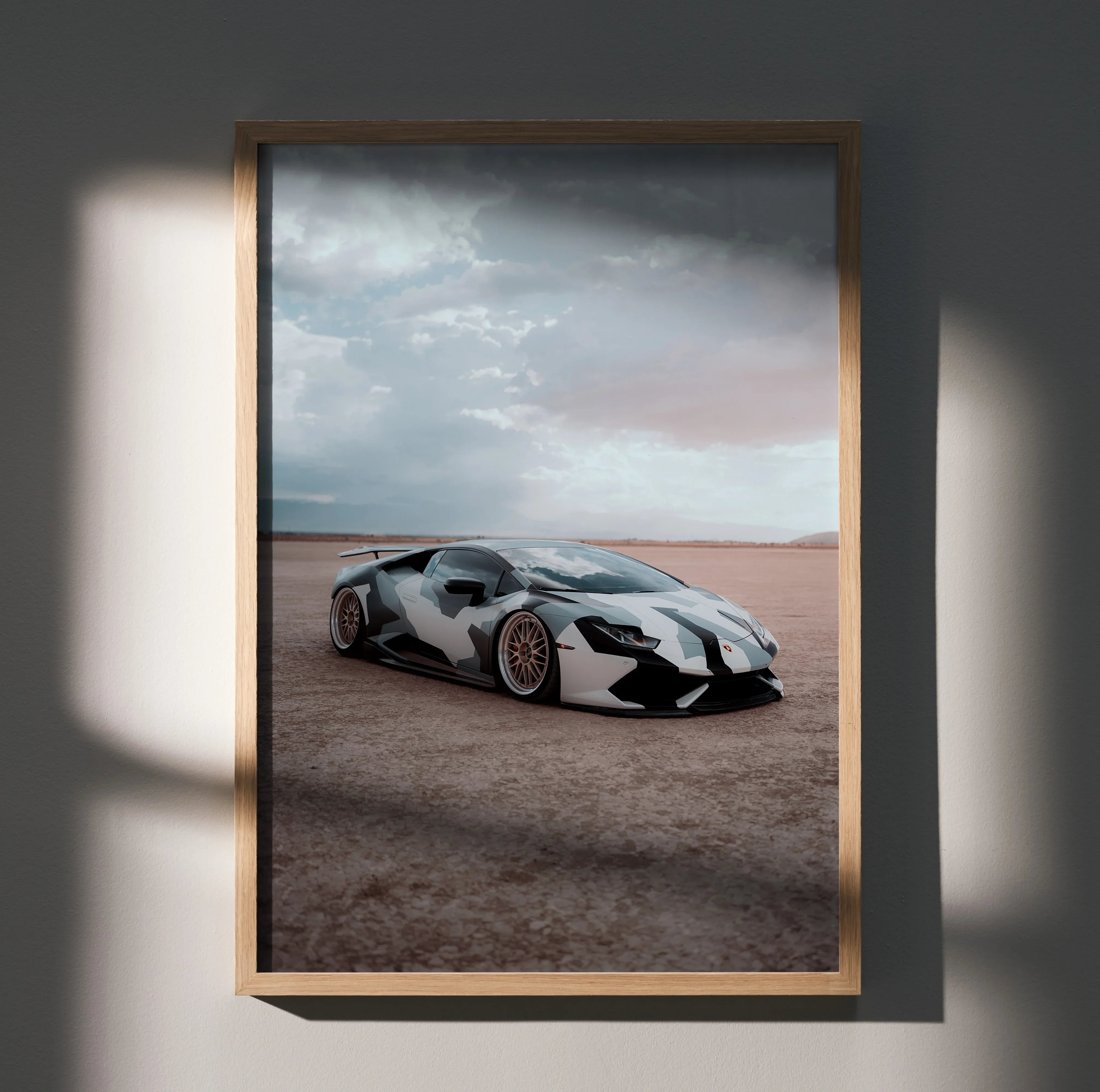 Lamborghini Huracan in desert setting poster wall art with cloudy sky and sleek design.