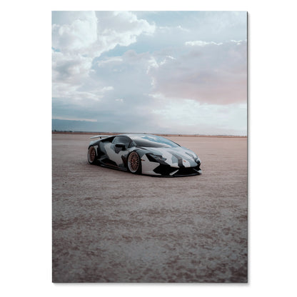 Poster of a sleek black-and-white Lamborghini Huracan parked on a vast open flat under a cloudy sky, wall art.